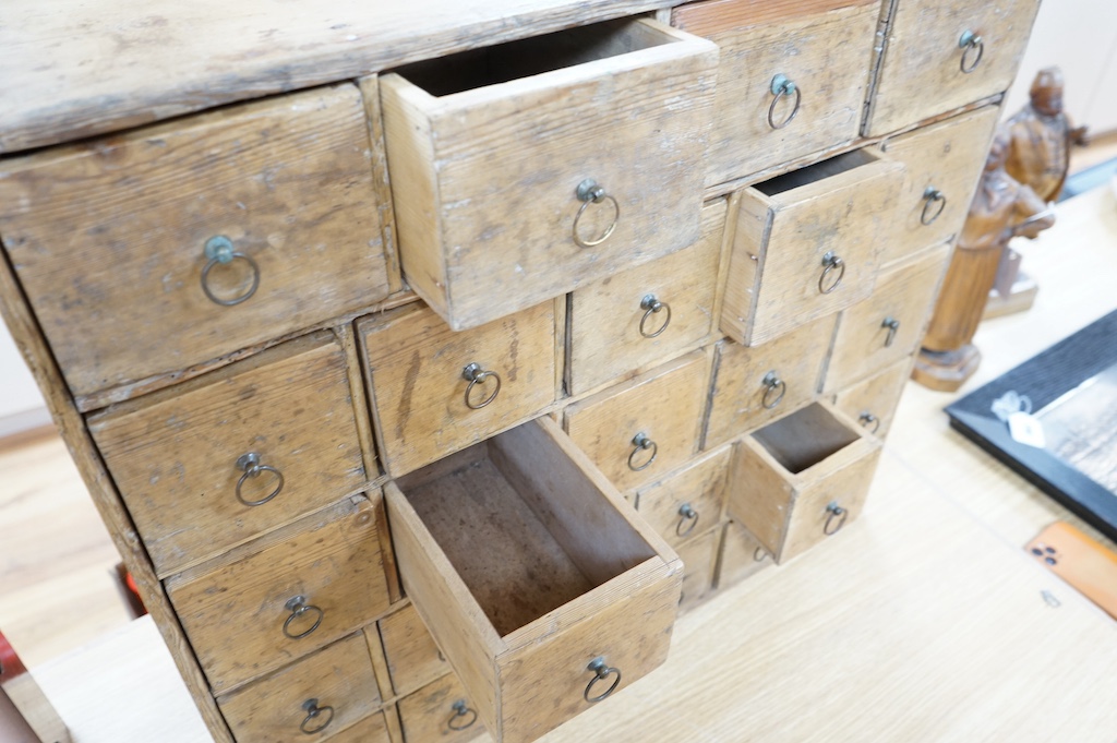 A Victorian stripped pine spice cabinet of twenty six drawers, 68cm wide x 63cm high x 22cm deep. Condition - fair to good